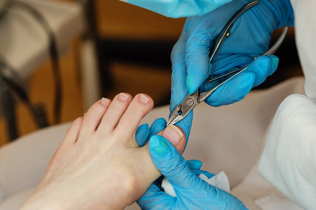 Chiropodist Trimming Cuticle of a Foot Up Close